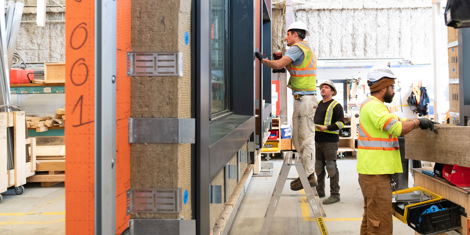 Insulation, cladding, windows and conduits are installed before the pre-fab panels are shipped.